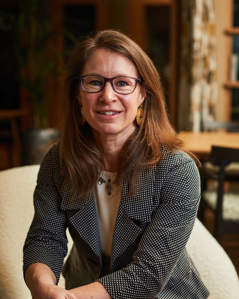 Amelia Armour poses for a portrait photo in an open plan office environment for Amadeus Capital Partners.