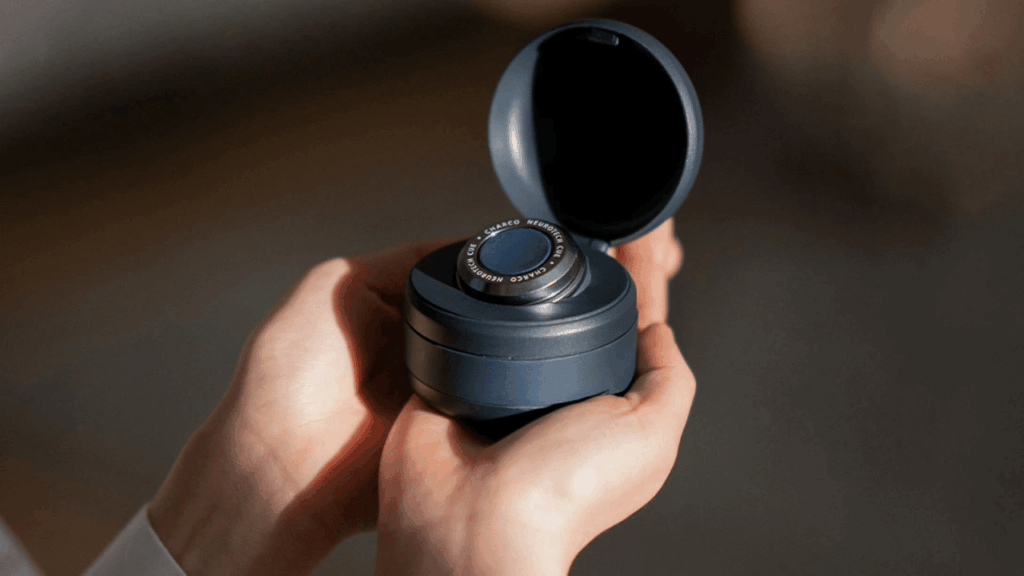 The Charco Neurotech CUE1 / CUE1+ wearable device being held in pair of hands.