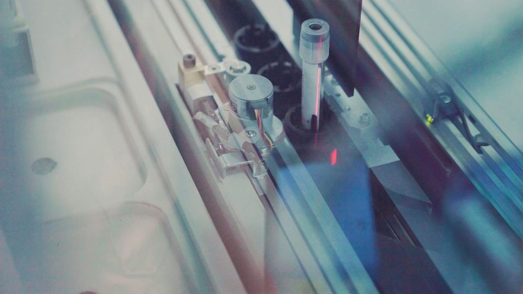 An image showing a laboratory machine which has a sample in a small test tube.