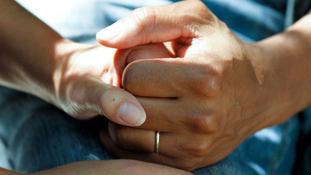 A photo of a person's hand being held by another to symbolise the patient care and connection created by the Doctify platform, which helps patients connect wit private healthcare providers.