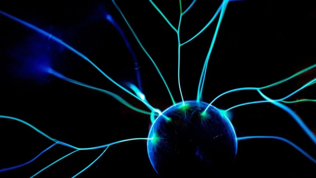 A spherical nucleus-like structure with several lighting-like branches in contact with it. This is to signify the quantum entanglement fabric necessary to enable quantum networking, the hardware which Nu Quantum is developing.