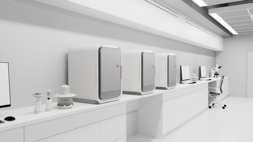 Several Oribiotech IRO manufacturing platforms lined up on a laboratory worktop. The device enables advanced cell and gene therapy for applications like cancer treatment. The device is rectangular, like a small desktop fridge, with the letters "IRO" printed on the door.