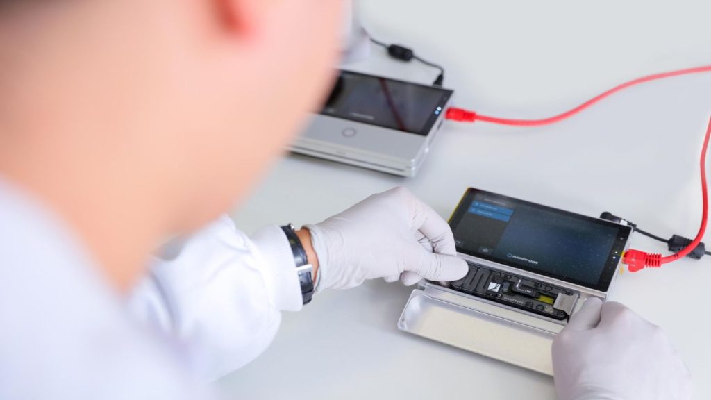 Hands using Oxford Nanopore Technologies lab minion mk1.