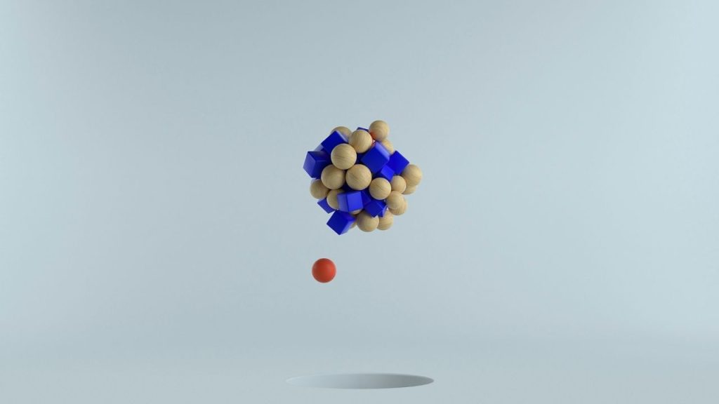 a conceptual image of spheres and blocks grouped together like a compound to represent the process of drug discovery and creation.