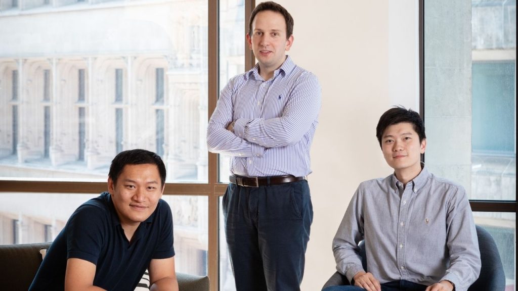 The three founders of PolyAI in the corner of a bright open plan office space.