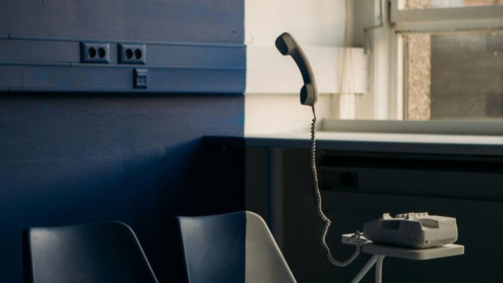 a telephone handset floating in mid-air as if the caller is invisible. The photo is a representation of the extremely lifelike voice AI agents which PolyAI develop for business contact centres.
