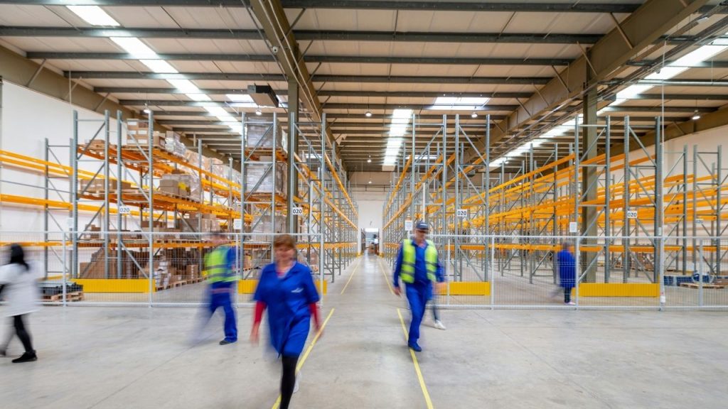 people working in a warehouse, representing the spaces which RoboK optimises with its technology.
