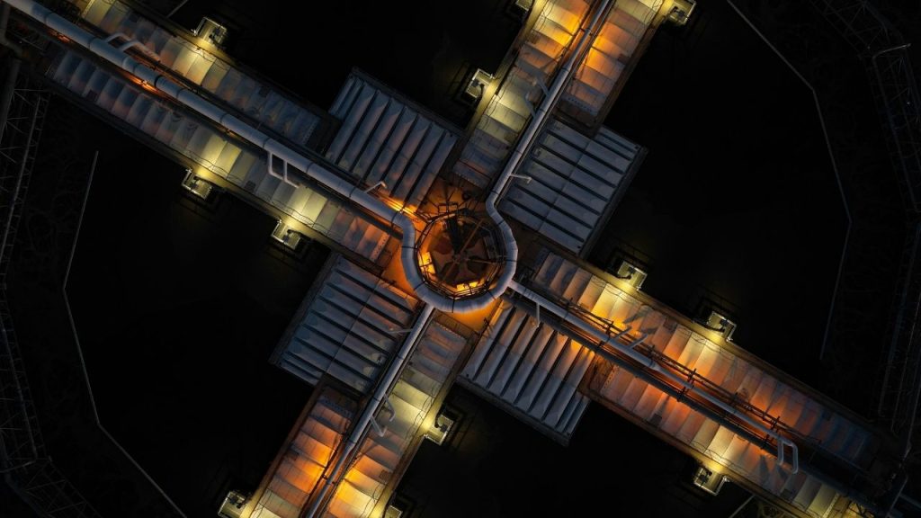 An aerial photo of an intersection of pipework on top of a building which represents the combining of quantum and AI technology that SandboxAQ is creating.