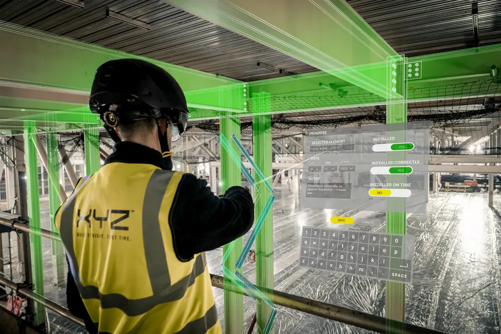 a photo of a person using the XYZ Relaity ATOM Augmented Reality headset to inspect a building on site.