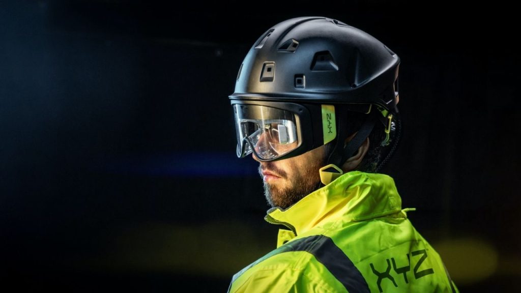 a photo of a man wearing the XYZ Reality ATOM helmet, which features engineering-grade augmented reality to display construction plans on-site.