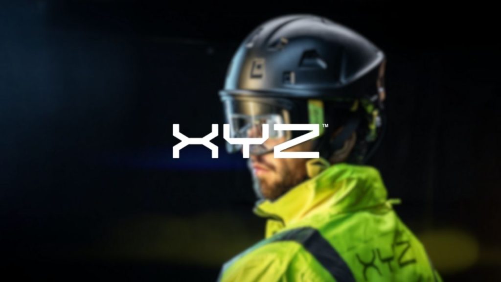 XYZ Reality logo overlaid on a photo of a man wearing the XYZ Reality ATOM helmet, which features engineering-grade augmented reality to display construction plans on-site.