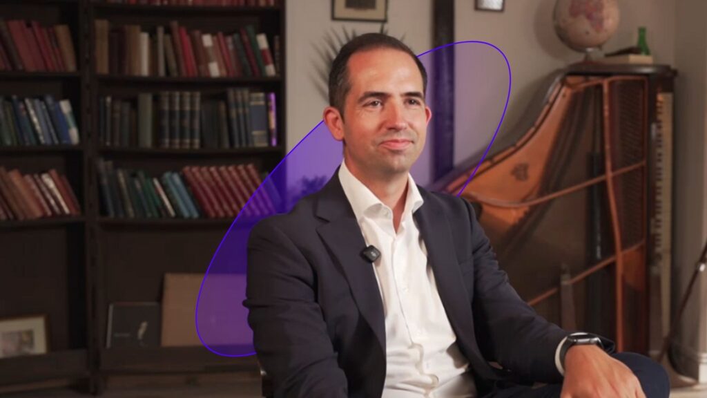 Studio interview for In Focus on AI in medical imaging and precision health, featuring Quibim CEO and co-founder Angel ALberich in a library setting.