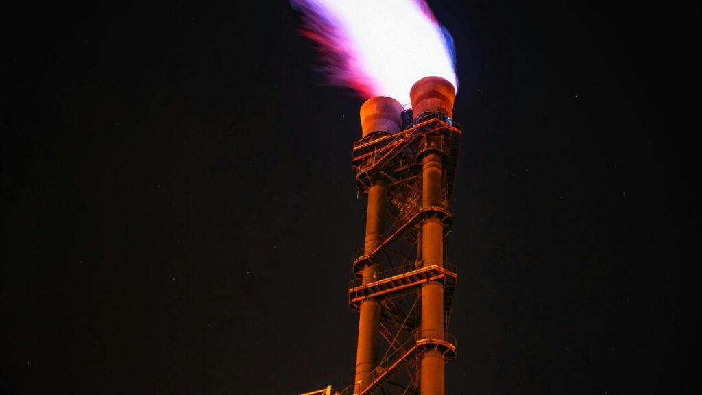 An industrial exhaust emitting flames to represent the biogas production process enabled by Vertus energy technology.