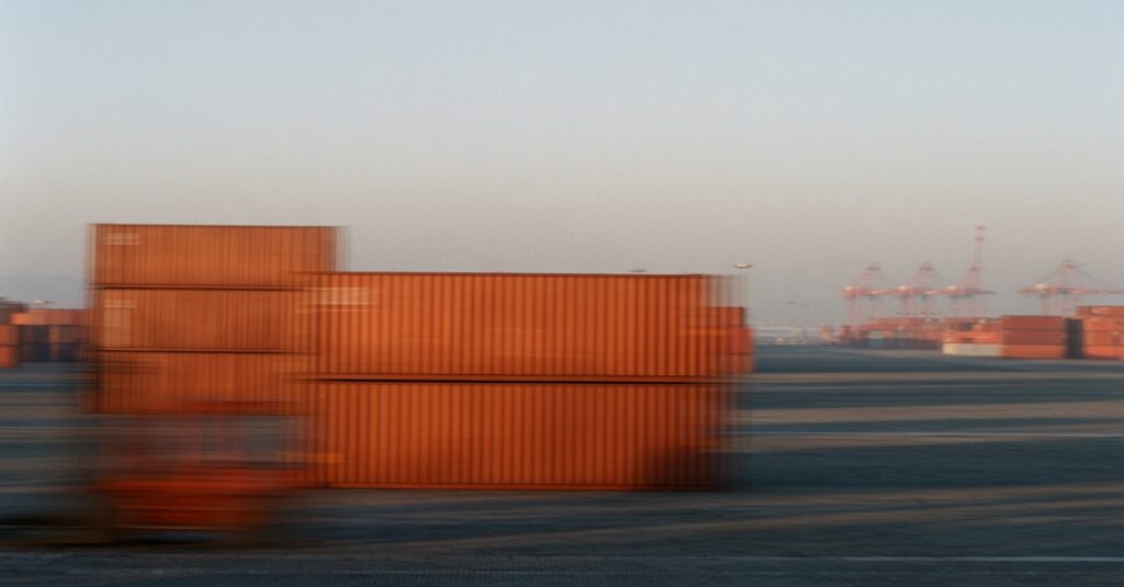 An AI-generated image of containers and a forklift in a shipyard.